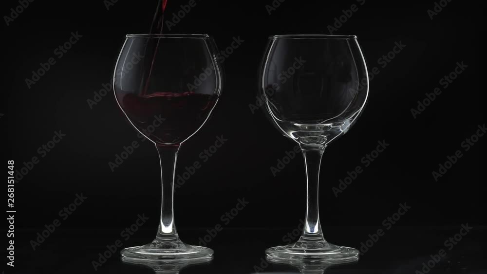 Rose wine. Red wine pour in two wine glasses over black background. Silhouette Rose wine. Red wine pour in two wine glasses over black background. Silhouette