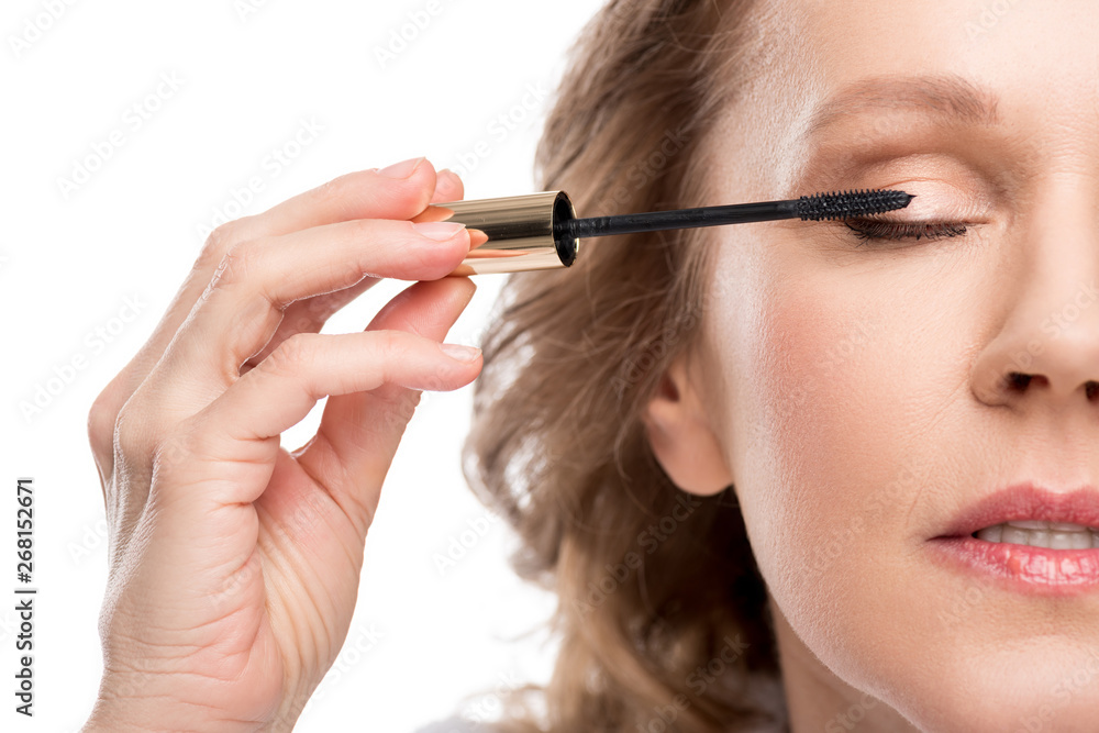 cropped view of mature woman applying mascara Isolated On White cropped view of mature woman applying mascara Isolated On White