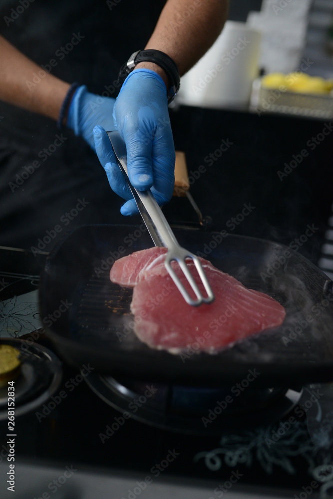 Fototapeta premium Making dinner at restaurant. Proffesional cooker