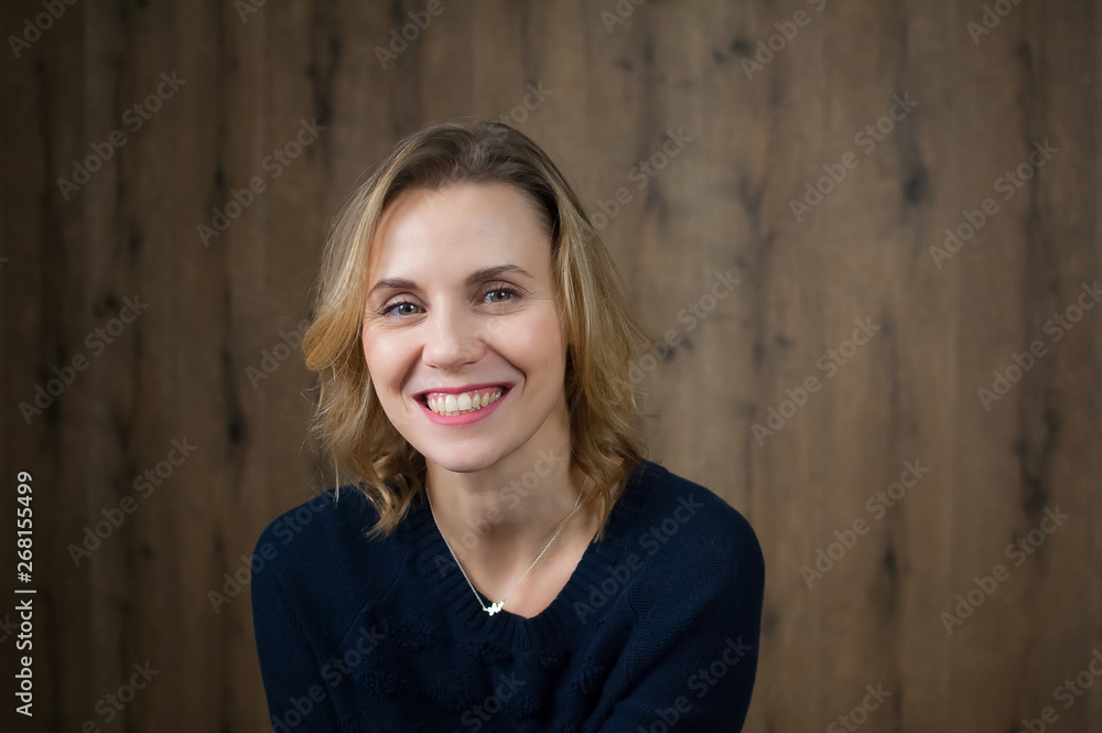 A beautiful young girl with a beautiful smile and a spark in her eyes. Art portrait in the studio A beautiful young girl with a beautiful smile and a spark in her eyes. Art portrait in the studio