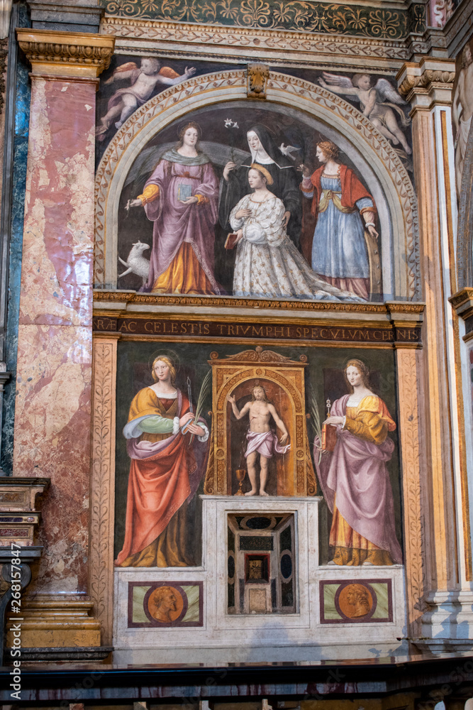 Italy, 03/28/2019: San Maurizio al Monastero Maggiore, 1518 church known as the Sistine Chapel of Milan, details of altarpiece and dividing wall in the faithful's area with frescoes by Aurelio Luini
