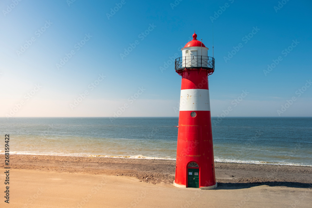 Traditional red white steel lighthouse in Westkapelle, Netherlands.