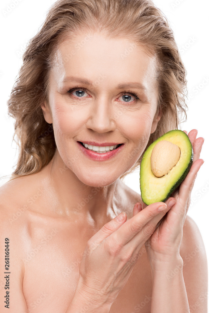 beautiful smiling nude middle aged woman posing with avocado Isolated On White beautiful smiling nude middle aged woman posing with avocado Isolated On White