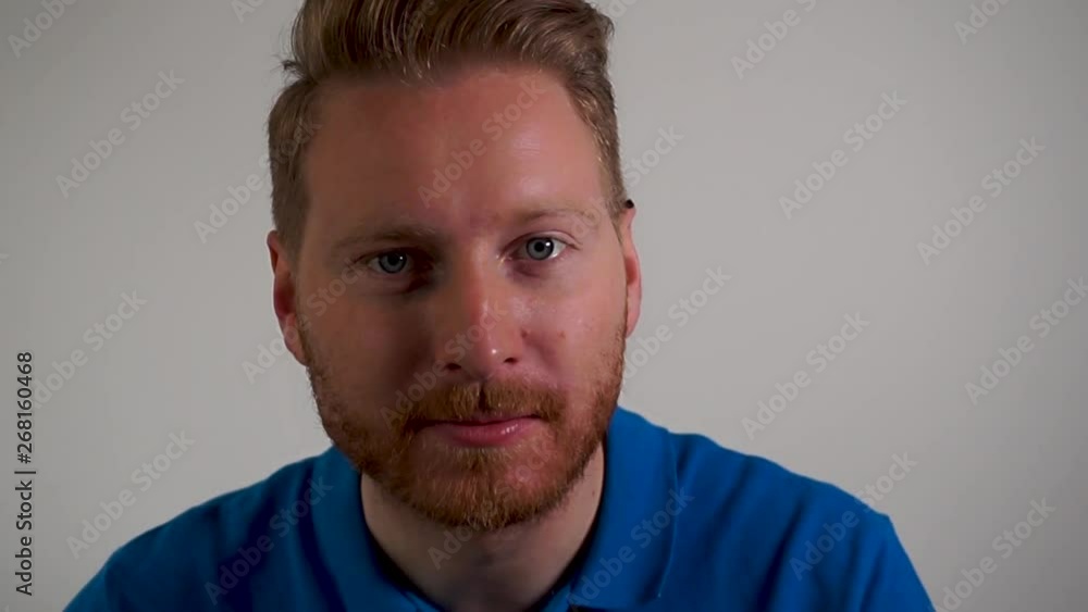 Caucasian young man watching a movie, eating popcorns and laughing, close up Caucasian young man watching a movie, eating popcorns and laughing, close up