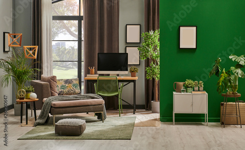 Modern living room with grey sofa and frame, green wall close up decoration in front of the window. photo