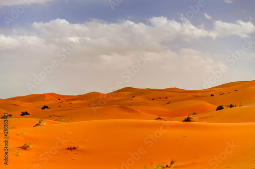Sand dunes and dramatic clouds in the Sahara Desert in MOrocco