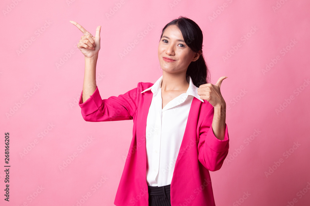 Young Asian woman point and thumbs up. Young Asian woman point and thumbs up.