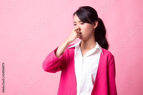 Young Asian woman  holding her nose because of a bad smell. © halfbottle