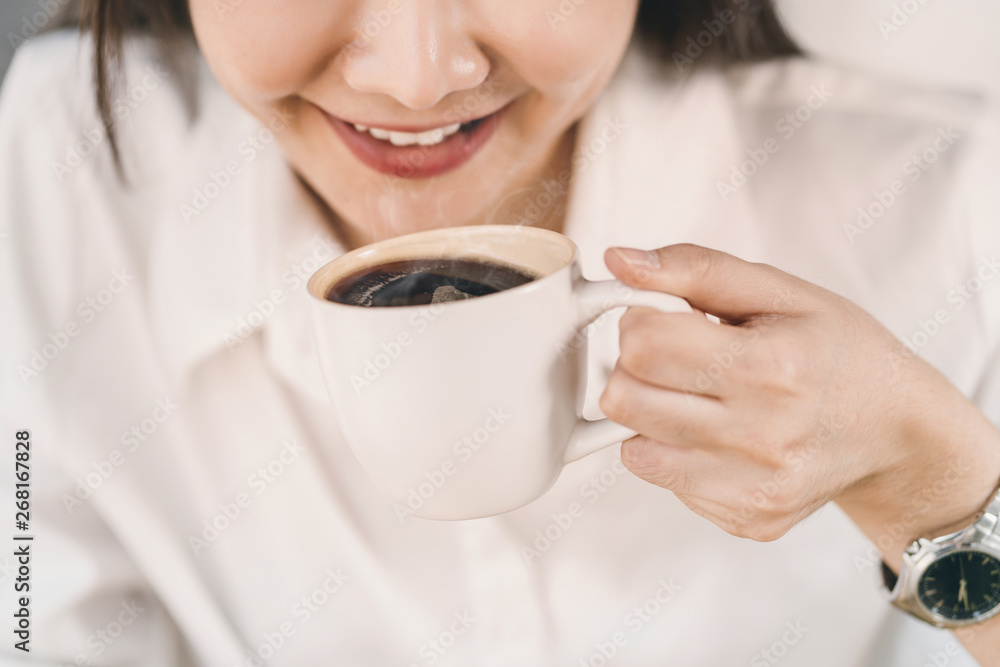 Close up woman in white shirt drinking coffee. Close up woman in white shirt drinking coffee.