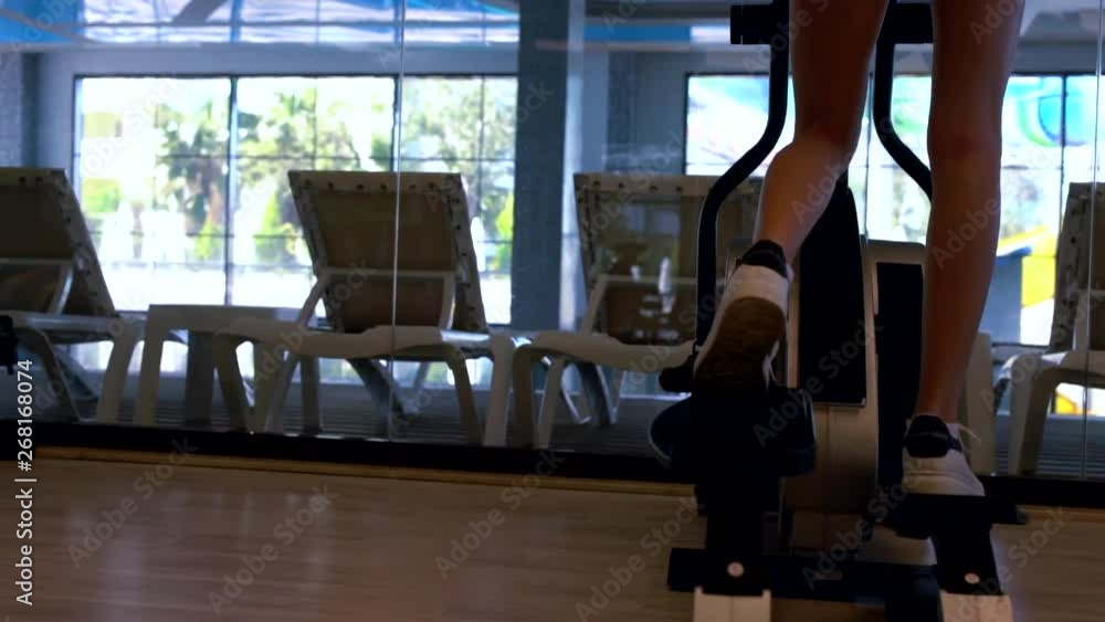 Close up of woman using running machine in gym Close up of woman using running machine in gym