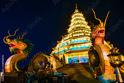 Beautiful dragon sculpture at night with dark sky background, Chiang Rai, northern of Thailand. photo