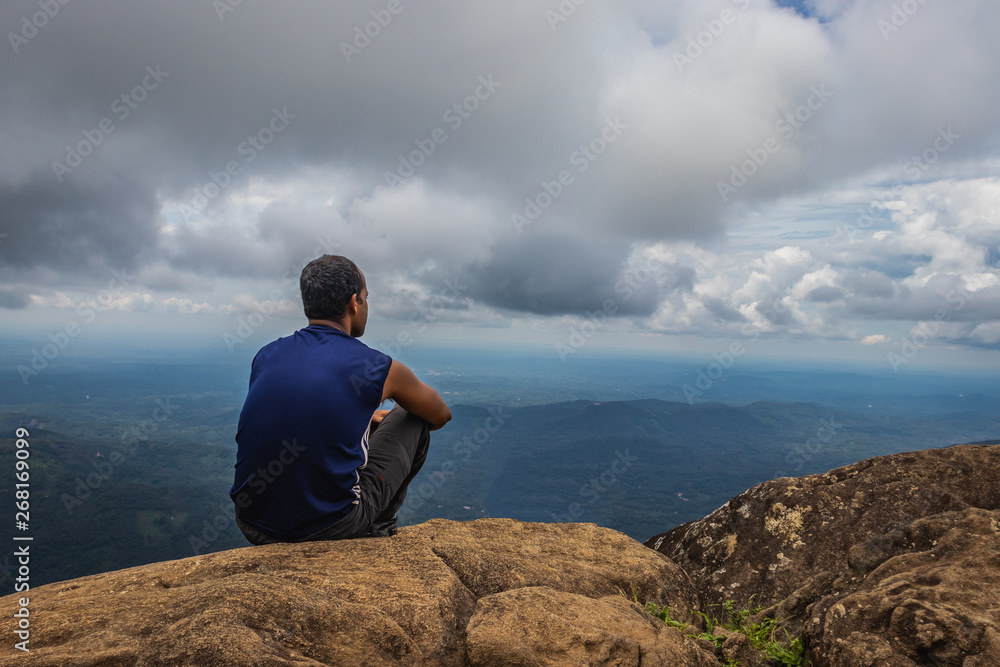 Man Isolated watching landscape from hilltop