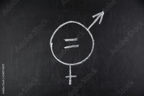 a symbol for gender equality drawn with chalk on a black chalkboard