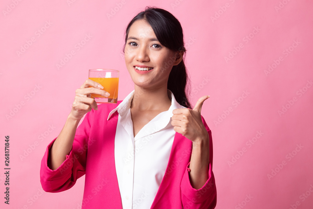 Young Asian woman thumbs up drink orange juice. Young Asian woman thumbs up drink orange juice.