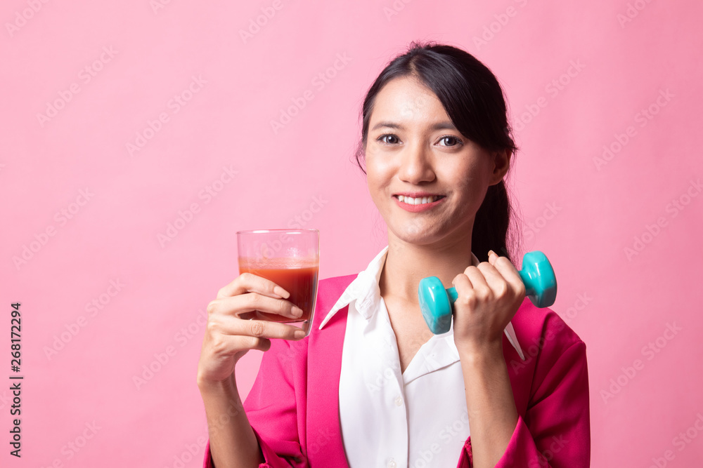 Healthy Asian woman with dumbbell and tomato juice. Healthy Asian woman with dumbbell and tomato juice.