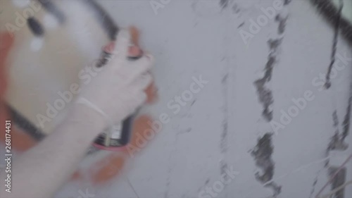 Graffiti artist painting with red spray paint can color street art vandalism