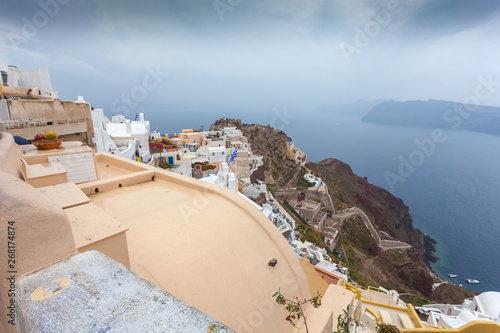 View of byzantine castle ruins and white houses of Oia village