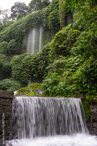 Enjoy the amazing scenery of Benang Kelambu waterfall in the tropical forest in Lombok, Indonesia with fresh and clean water photo