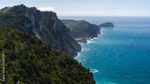 Beautiful view over the Tinetto, Tino and Palmaria islands as seen from a hiking trail in Porto Venere, La Spezia, Italy, on a hazy summer day.