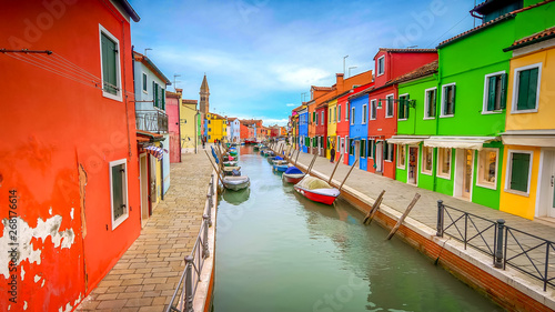 Colorful fisherman's homes dot either side of a canal  in the village of Burano in Venice, Italy © CrackerClips