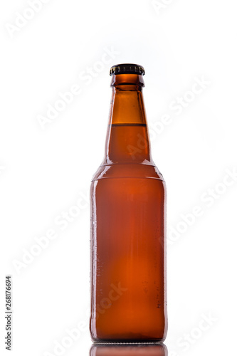 Bottle of white belgian beer over white background with reflection