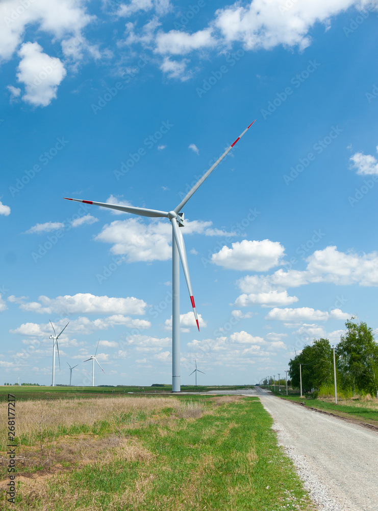 View on alternative energy windmills in a windpark in Ulyanovsk in front of a blue sky