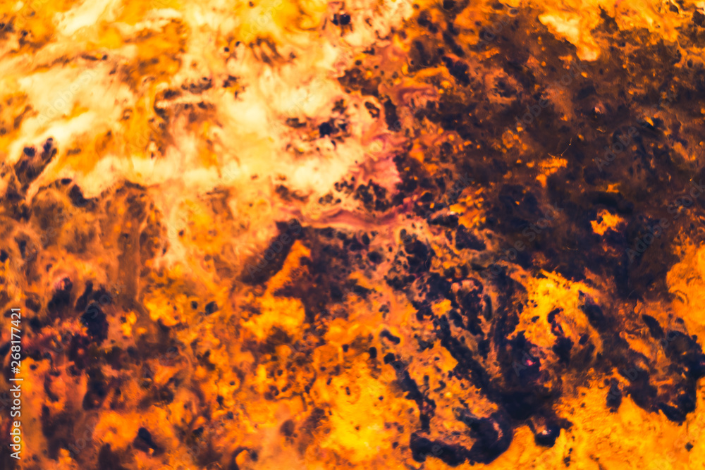 Abstract art texture background. Closeup of bonfire design. Orange and brown paint splash with marbled effect. Abstract art texture background. Closeup of bonfire design. Orange and brown paint splash with marbled effect.