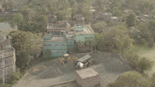 Bulldozer offload overturned track in India - aerial 4k ungraded/flat photo