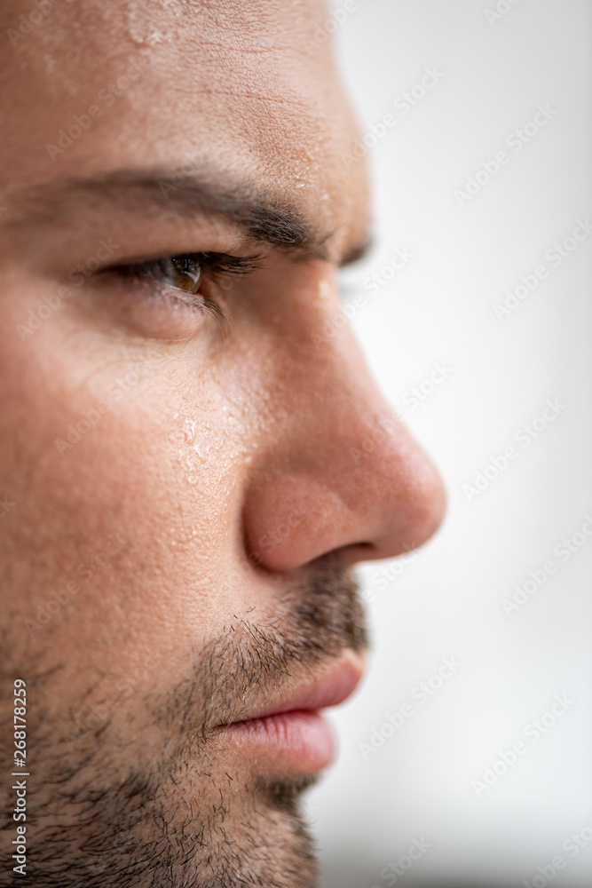 portrait of handsome man with sweaty face suffering from heat on white background portrait of handsome man with sweaty face suffering from heat on white background
