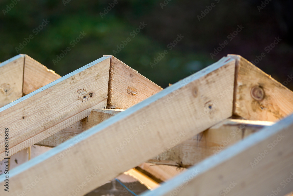 Close-up detail of roof frame of rough wooden lumber beams on background of misty mountain landscape in ecological area. Building, roofing, construction and renovation concept. Close-up detail of roof frame of rough wooden lumber beams on background of misty mountain landscape in ecological area. Building, roofing, construction and renovation concept.