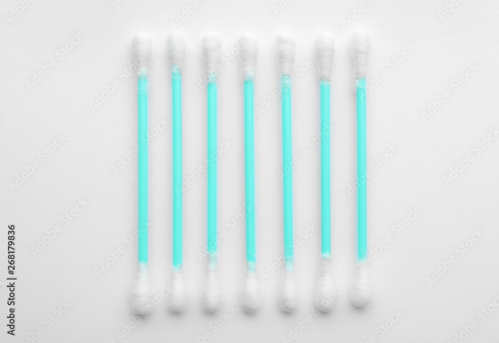 Plastic cotton swabs on white background, top view Plastic cotton swabs on white background, top view