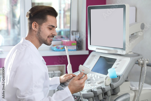 Sonographer using modern ultrasound machine in clinic