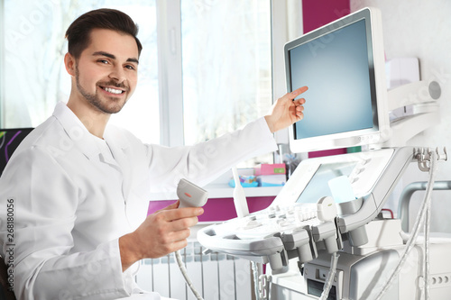 Sonographer using modern ultrasound machine in clinic