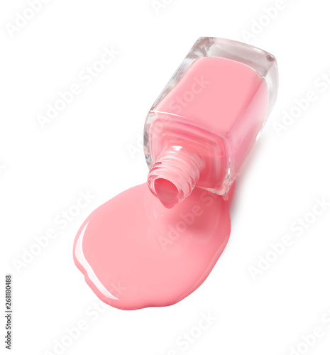 Spilled color nail polish with bottle on white background