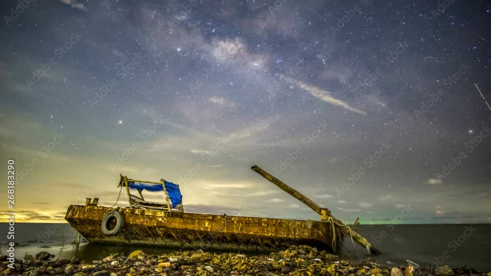 The Milky Way in a depressed atmosphere has a moon rising to the left. And there are clouds with rain and right lightning.