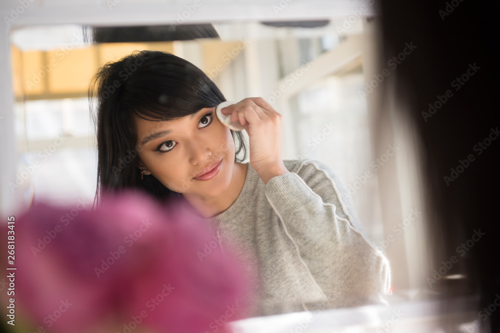 Woman applying make-up to face Woman applying make-up to face