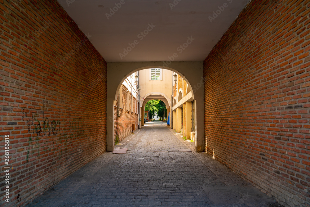 arch and brick walls of a residential building in Tbilisi