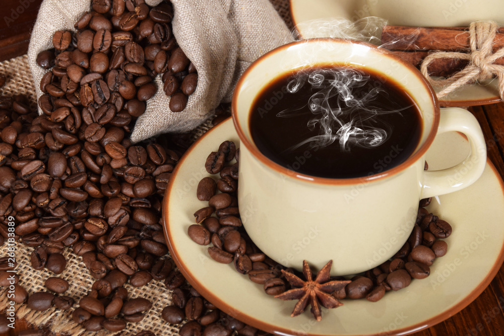 Fototapeta premium coffee in cups and roasted coffee grains