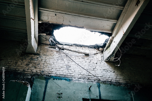 Hole in the ceiling in the destroyed building, war