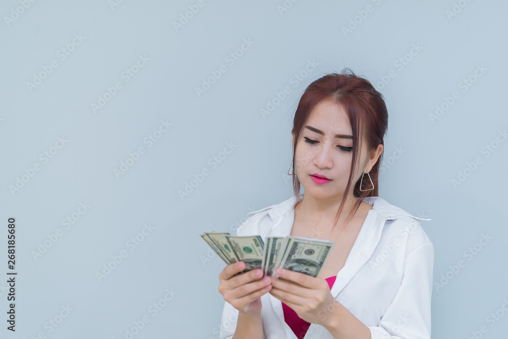 Portrait of asian sexy woman with a lot of money on white background,thailand people,The rich business woman concept Portrait of asian sexy woman with a lot of money on white background,thailand people,The rich business woman concept
