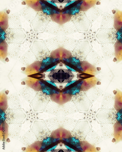 Drawing made with colorful crystals inside old kaleidoscope