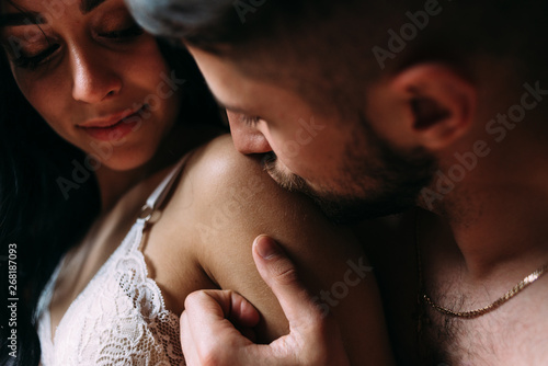 man and woman caress each other with kisses. Foreplay before sex photo