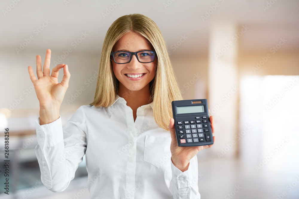 Portrait of happy woman with calculator in business center Portrait of happy woman with calculator in business center