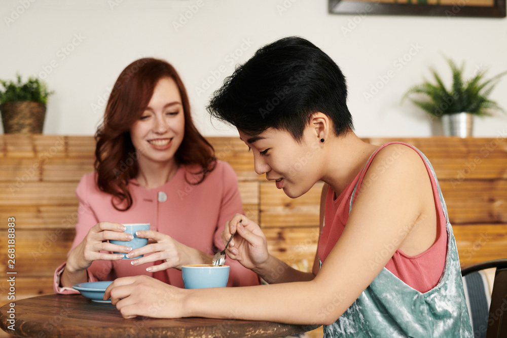 Girlfriends talking over coffee