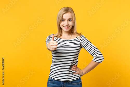 Beautiful smiling young blonde woman in striped clothes looking camera isolated on bright yellow orange wall background, studio portrait. People sincere emotions lifestyle concept. Mock up copy space. © ViDi Studio