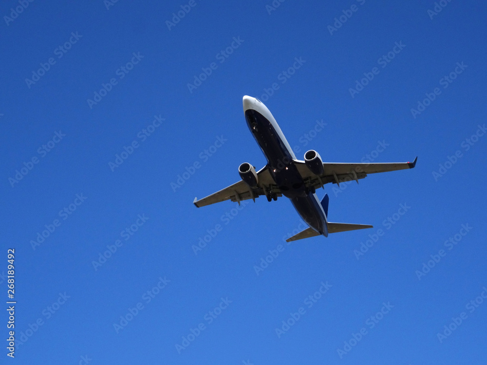 plane passing over my head on a day with blue sky plane passing over my head on a day with blue sky