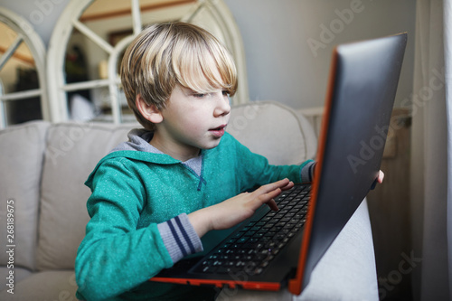 Child using a laptop photo