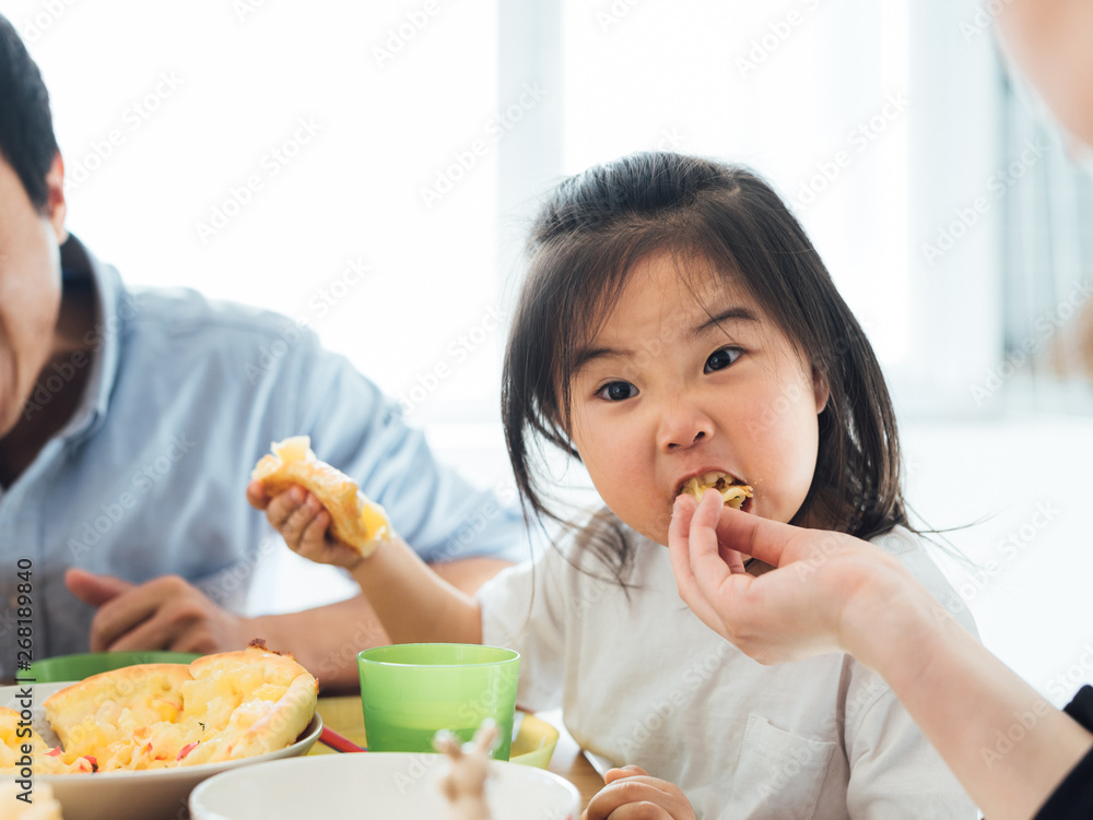 Toddler girl sitting and eating at home Toddler girl sitting and eating at home