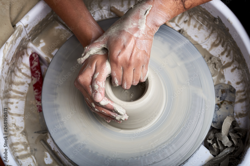 Sculptor making vase on pottery wheel. Stock Photo Adobe Stock