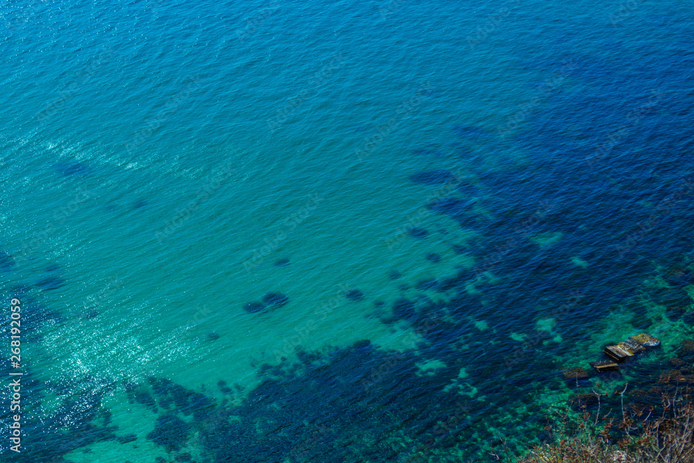 Texture of blue sea, seen from above, flat lay.